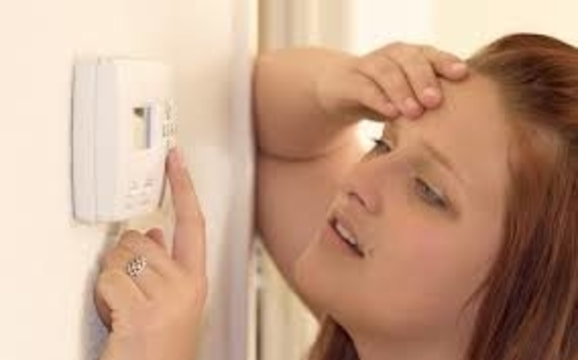 Woman changing Thermostat