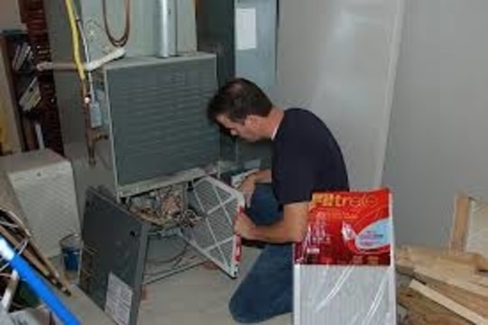 man changing furnace filter
